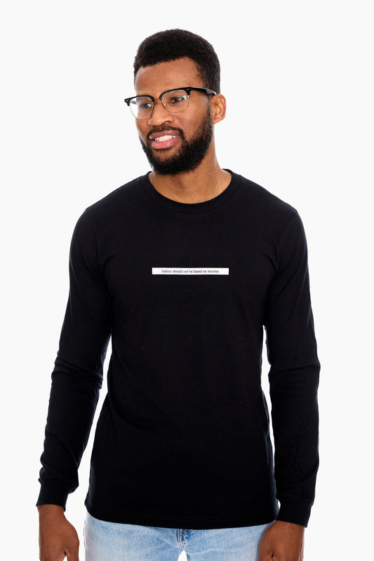 A man wearing a black long-sleeved T-shirt with the word 'TRUTH' printed across the chest in white letters.