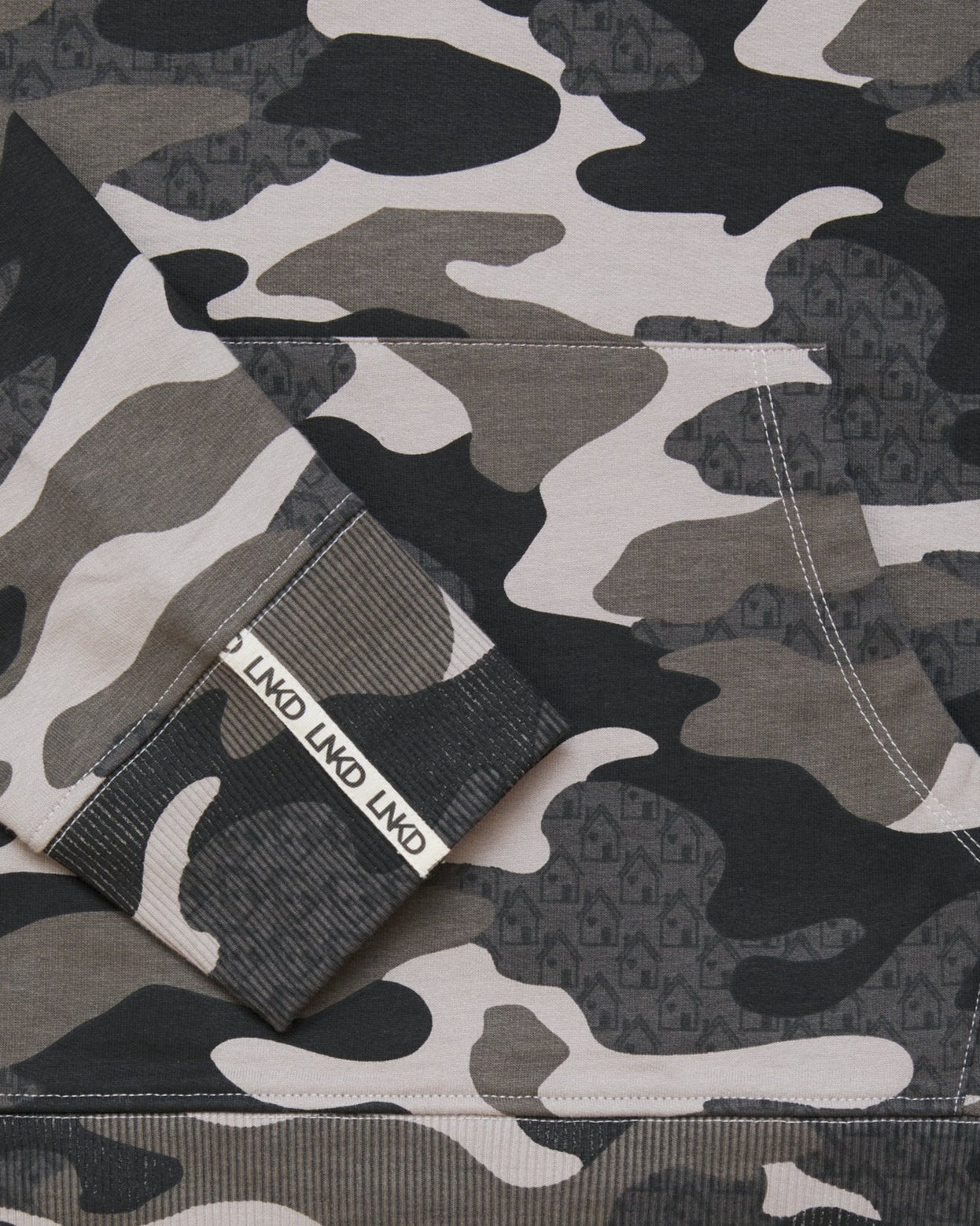 Close up of grey Camo printed sweatshirt with house graphic within the print.