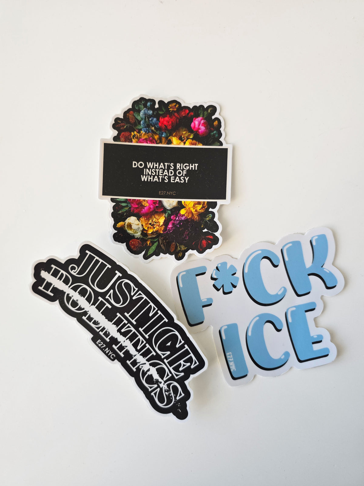 Three stickers with different designs and text on a white background