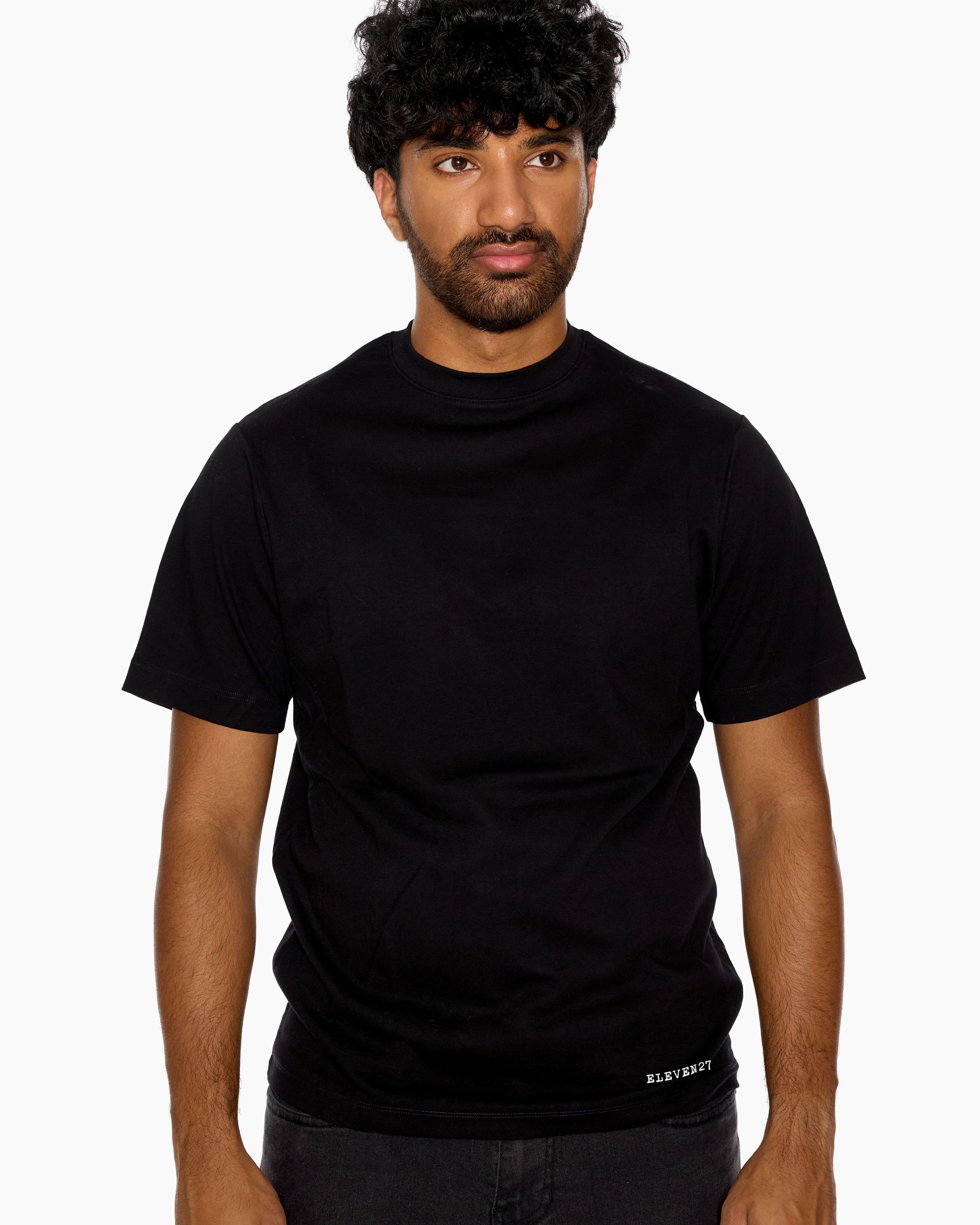Man wearing a black t-shirt with Eleven27 logo on a white background