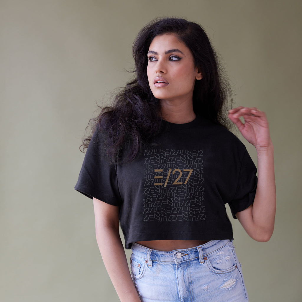 Exotic model wearing Black Cropped Tshirt with E27 Layered Logo at the centerfront, and destructed jeans