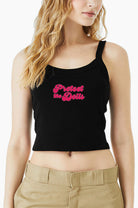 Black Eleven27 tank top with pink "Protect The Dolls" worn by a person on a white background