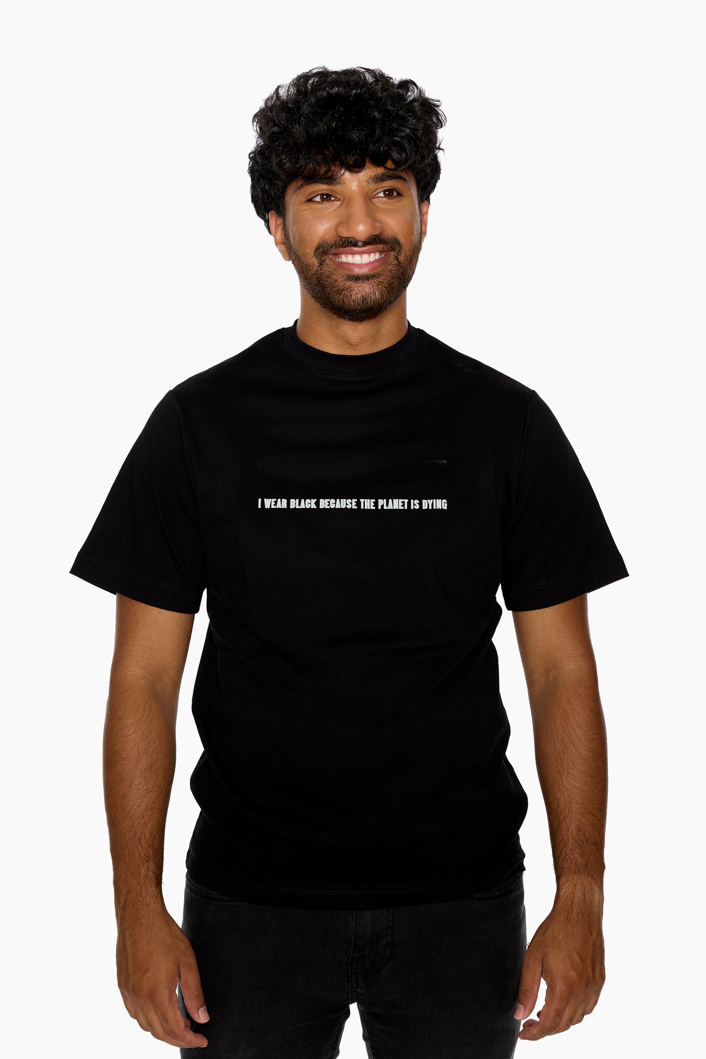 Man wearing a black t-shirt with "I wear black because the planet is dying" text on a white background
