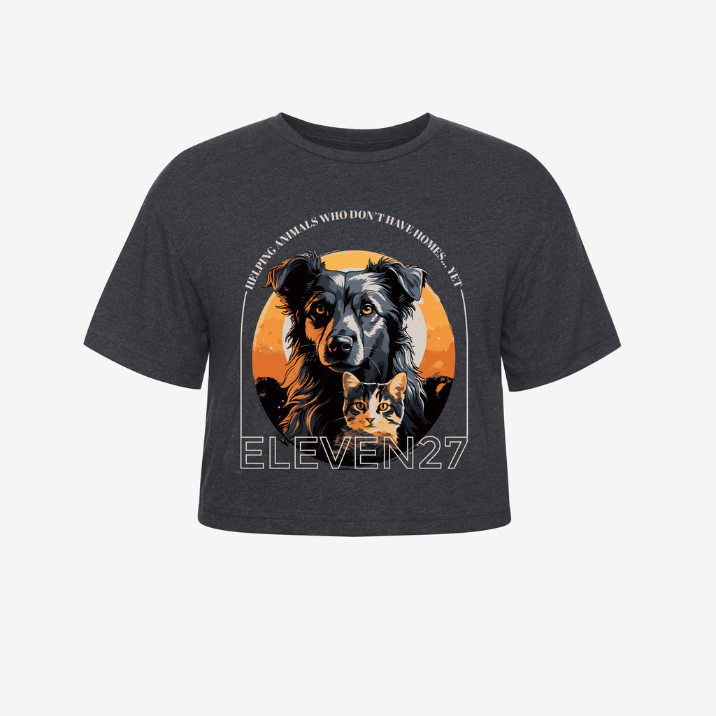 Dark Heather Grey cropped tshirt with graphic of a dog and a cat in a gray, orange, black color scheme. Tshirt sales support an animal shelter in need of support. Graphic also includes the brand name Eleven27 in ivory outline, with the words "Helping animals who don't have homes... yet".