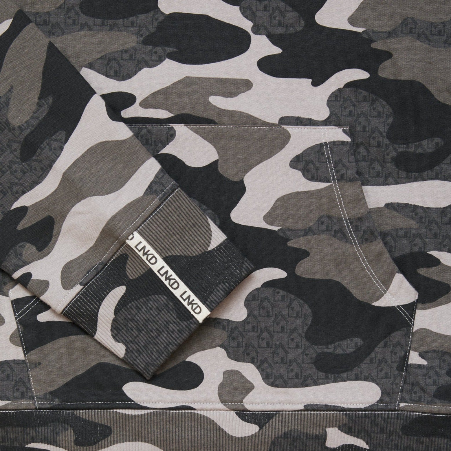 Close up of grey Camo printed sweatshirt with house graphic within the print.