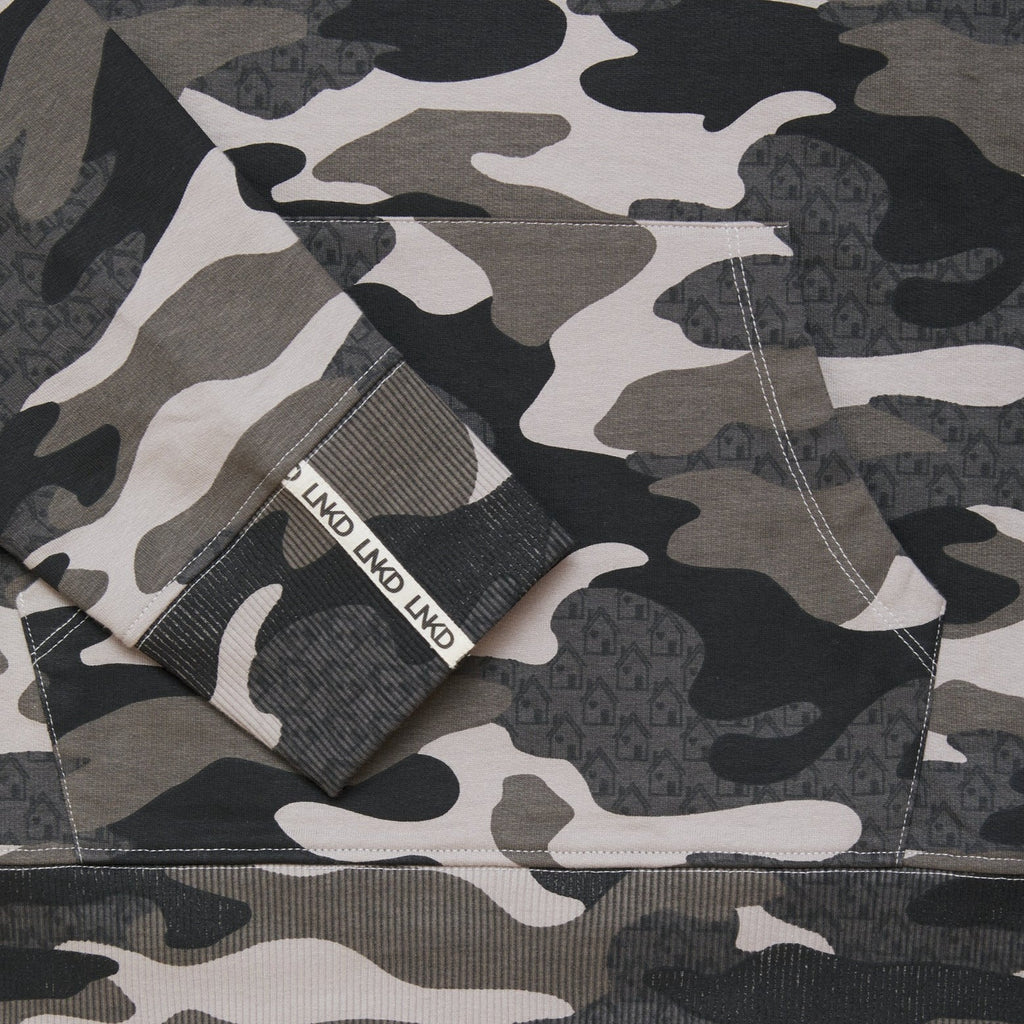 Close up of grey Camo printed sweatshirt with house graphic within the print.