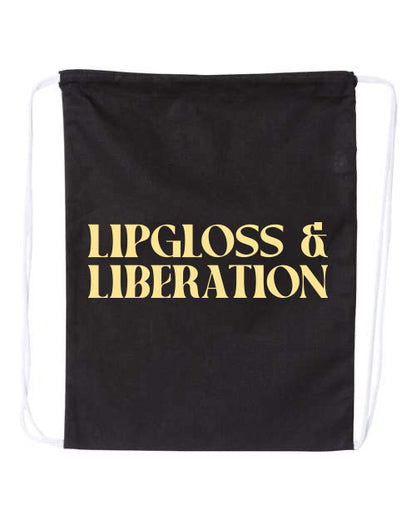 Black drawstring bag with 'Lipgloss & Liberation' text in butter yellow on a white background