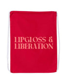 Red drawstring bag with 'Lipgloss & Liberation' coral text on a white background