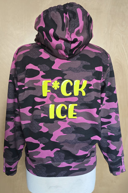 Camouflage hoodie with lime "F*ck ICE" text  graphic on a beige background