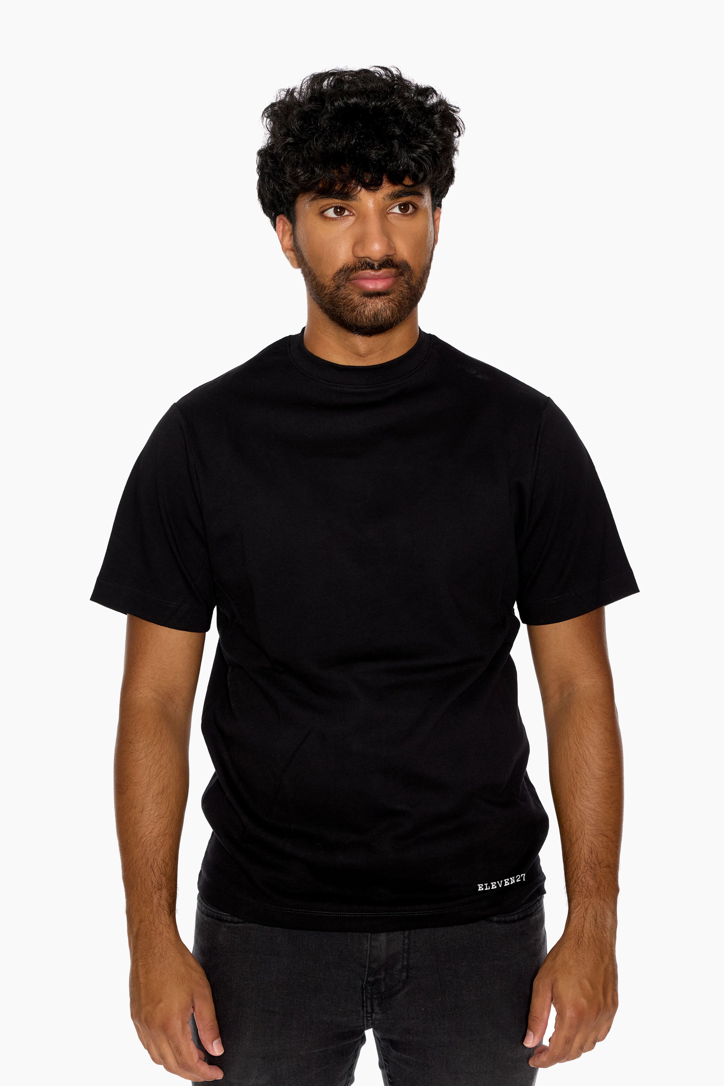 Man wearing a black t-shirt with Eleven27 logo on a white background